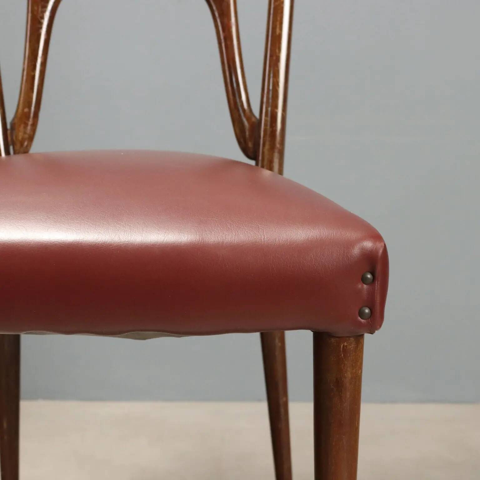 Set of six 1950s chairs with burgundy seats.