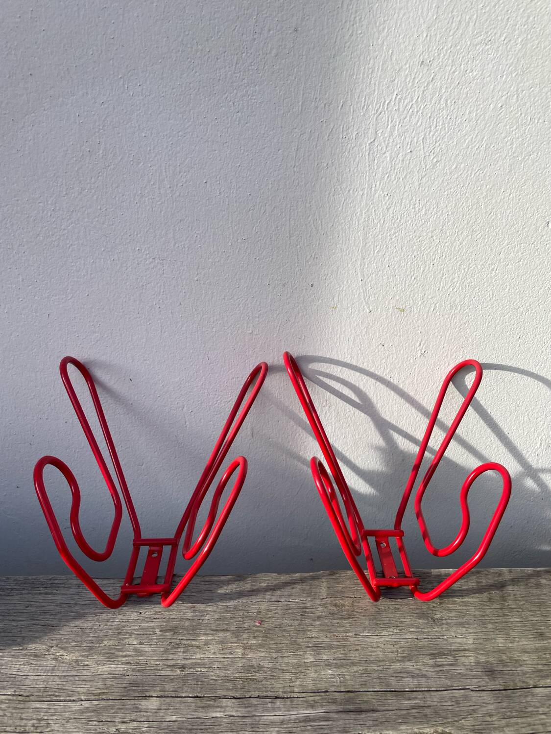 Pair of red metal wall hooks