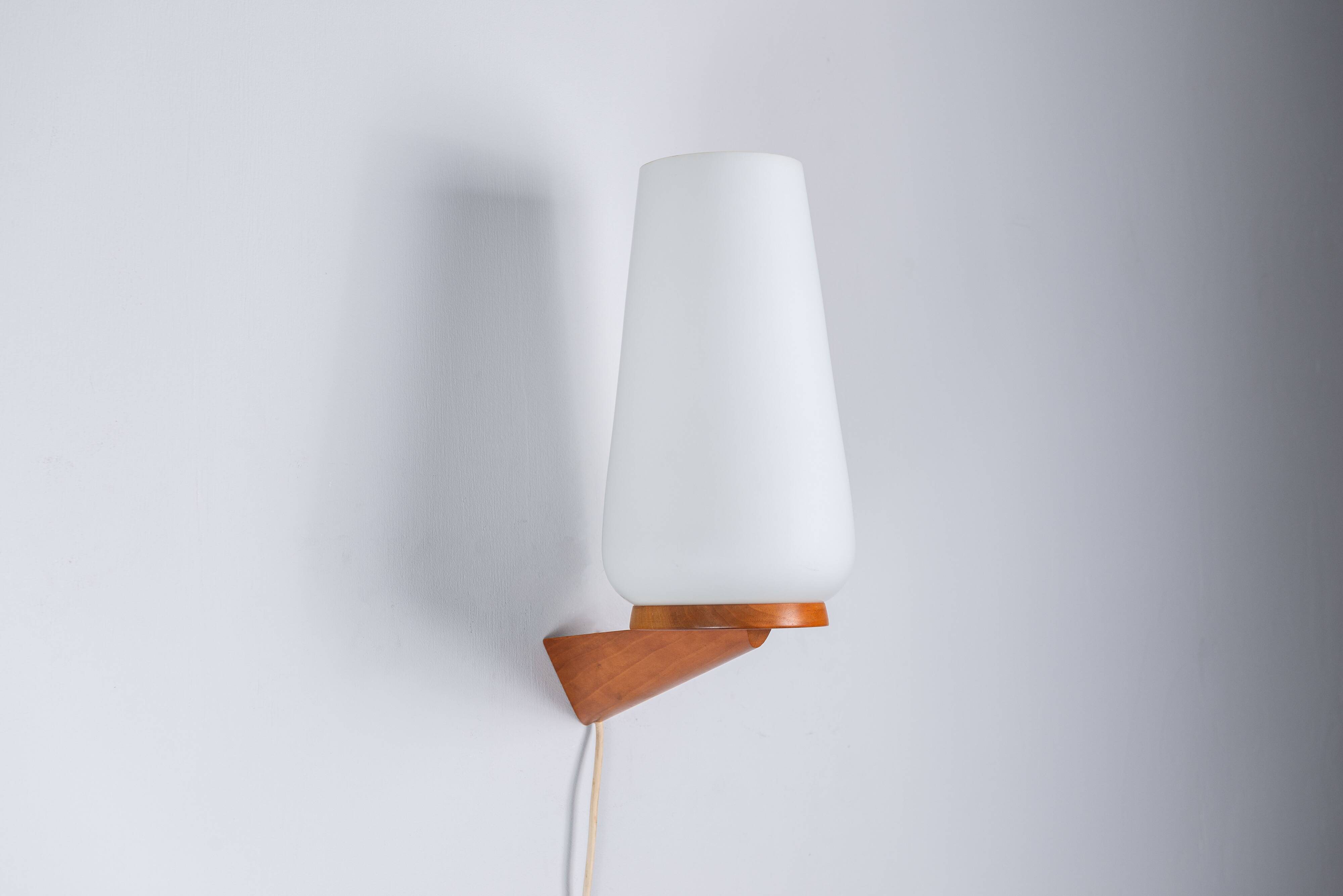 Wall lamp with opal glass shade on wooden base by Philips