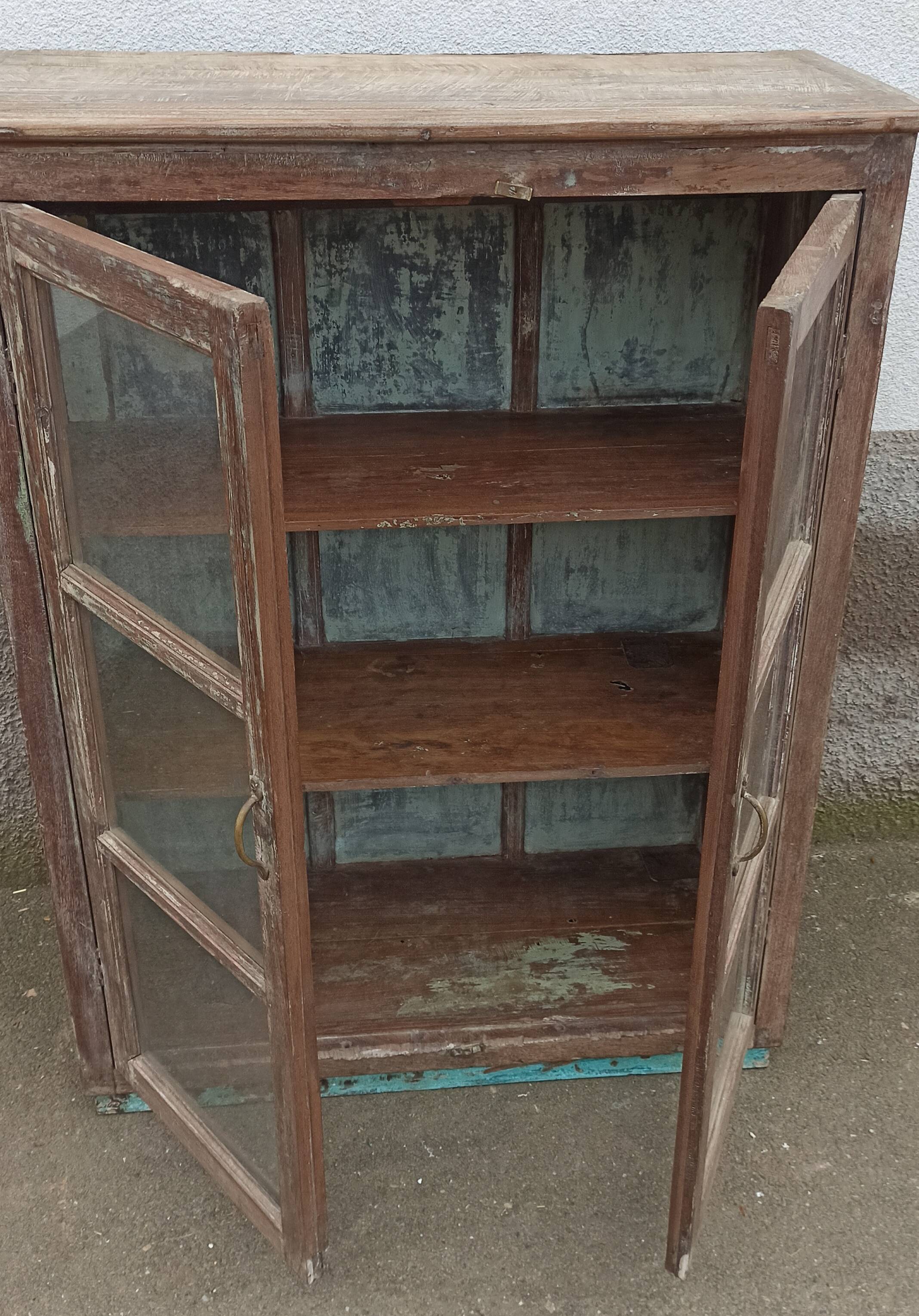 Old glazed wooden cabinet with metal bottom