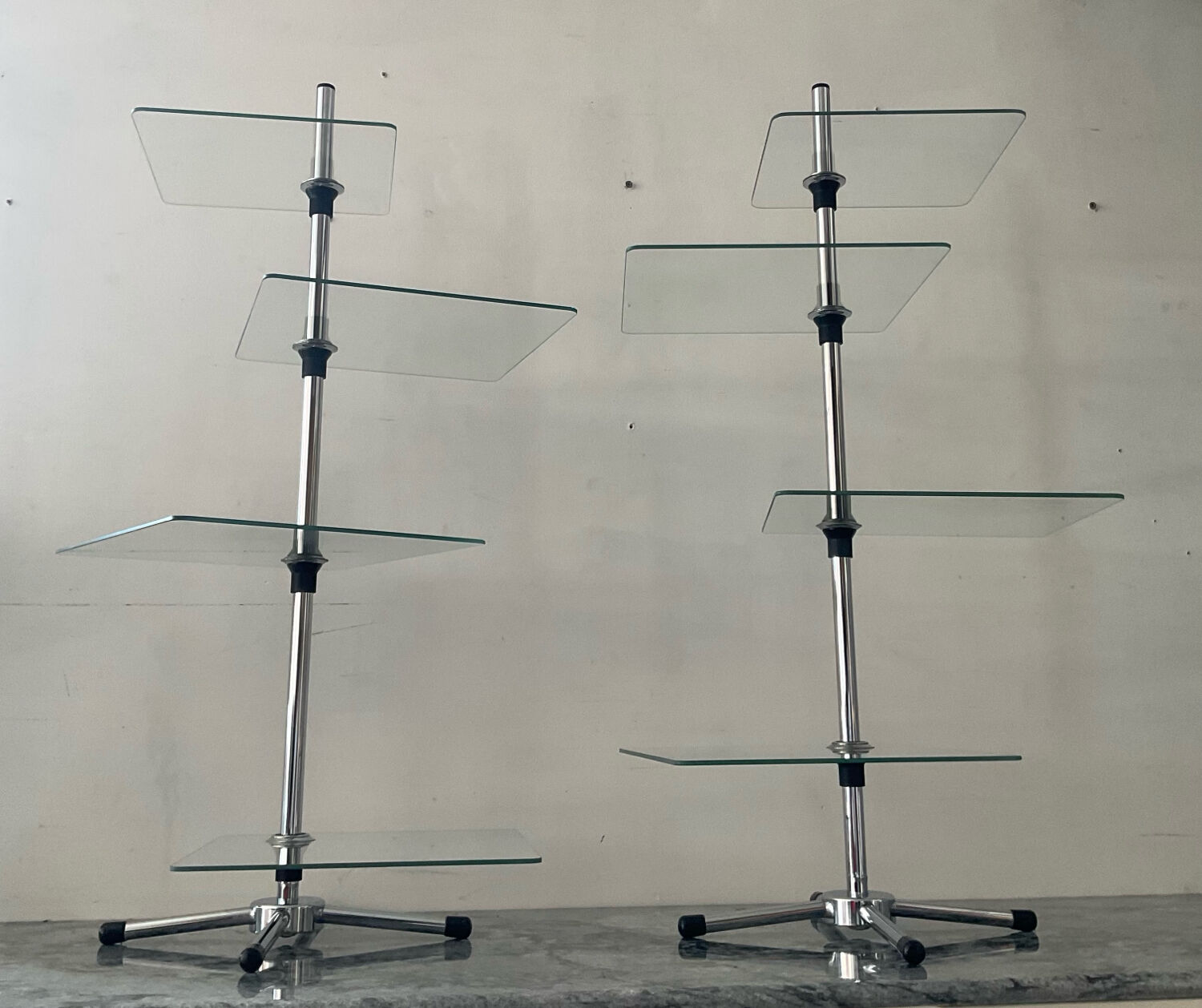 A pair of vintage side tables in glass and chrome metal.