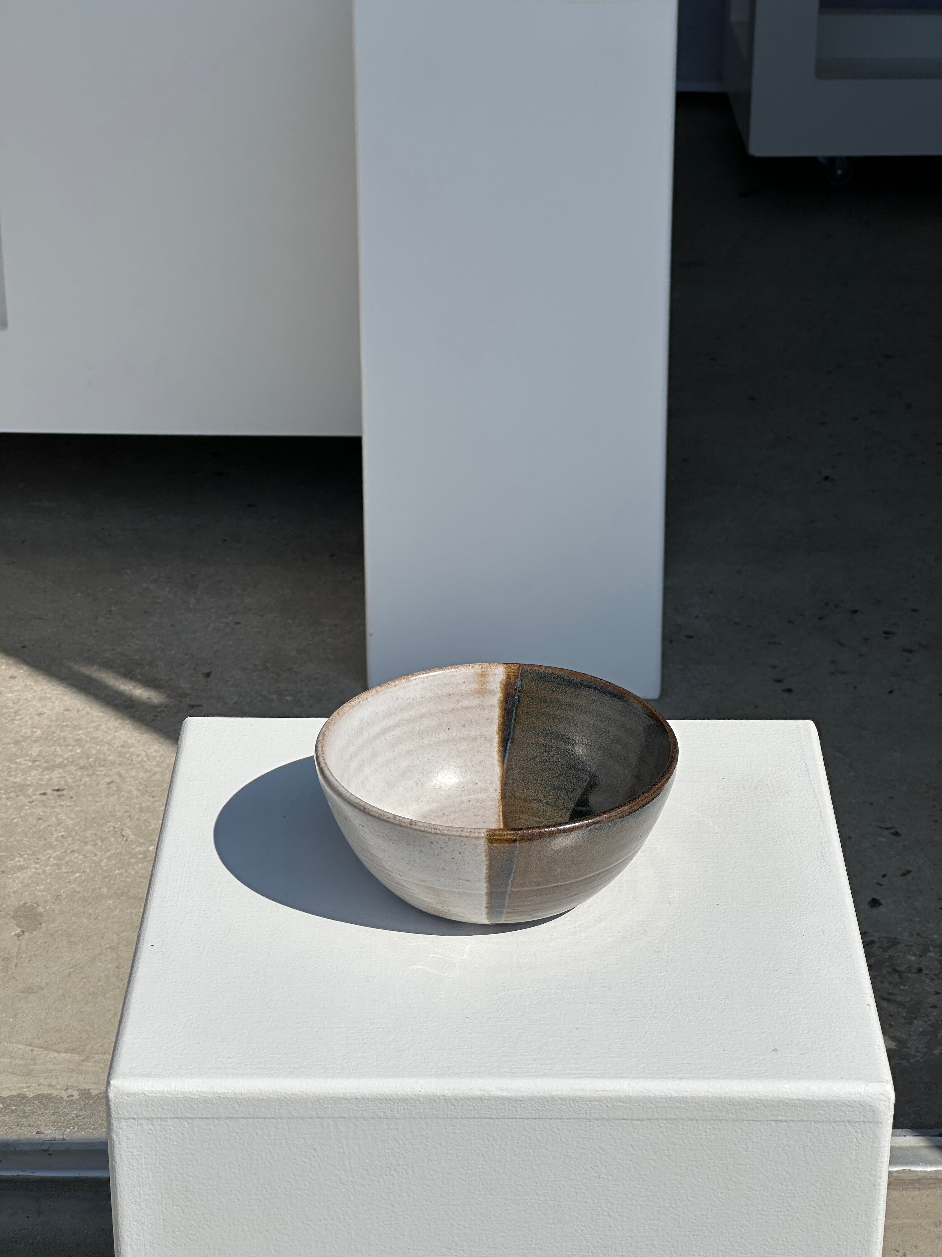 White and glossy brown two-tone ceramic bowl, matt earth