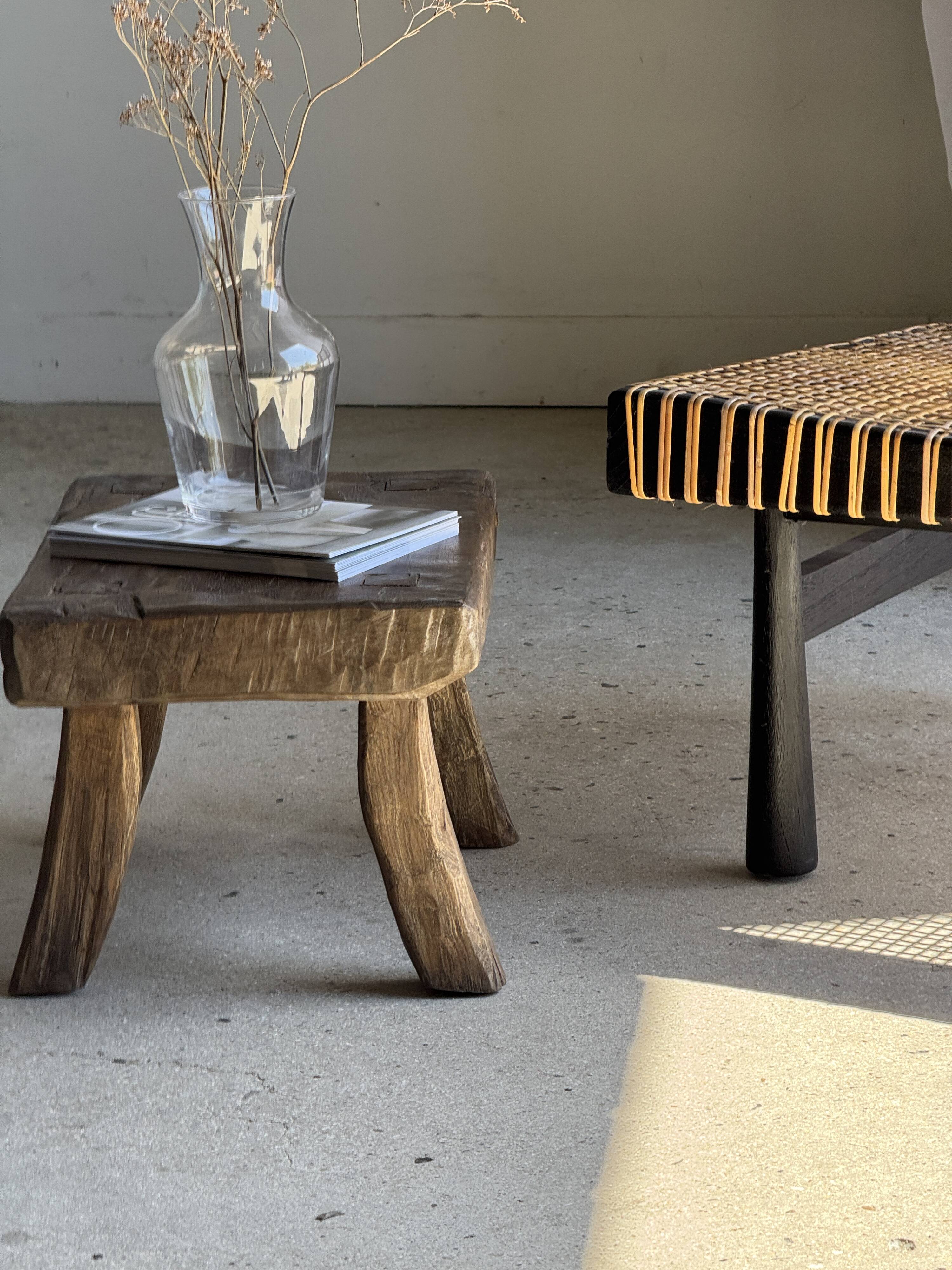 Small stool, rectangular solid teak side table with curved legs.