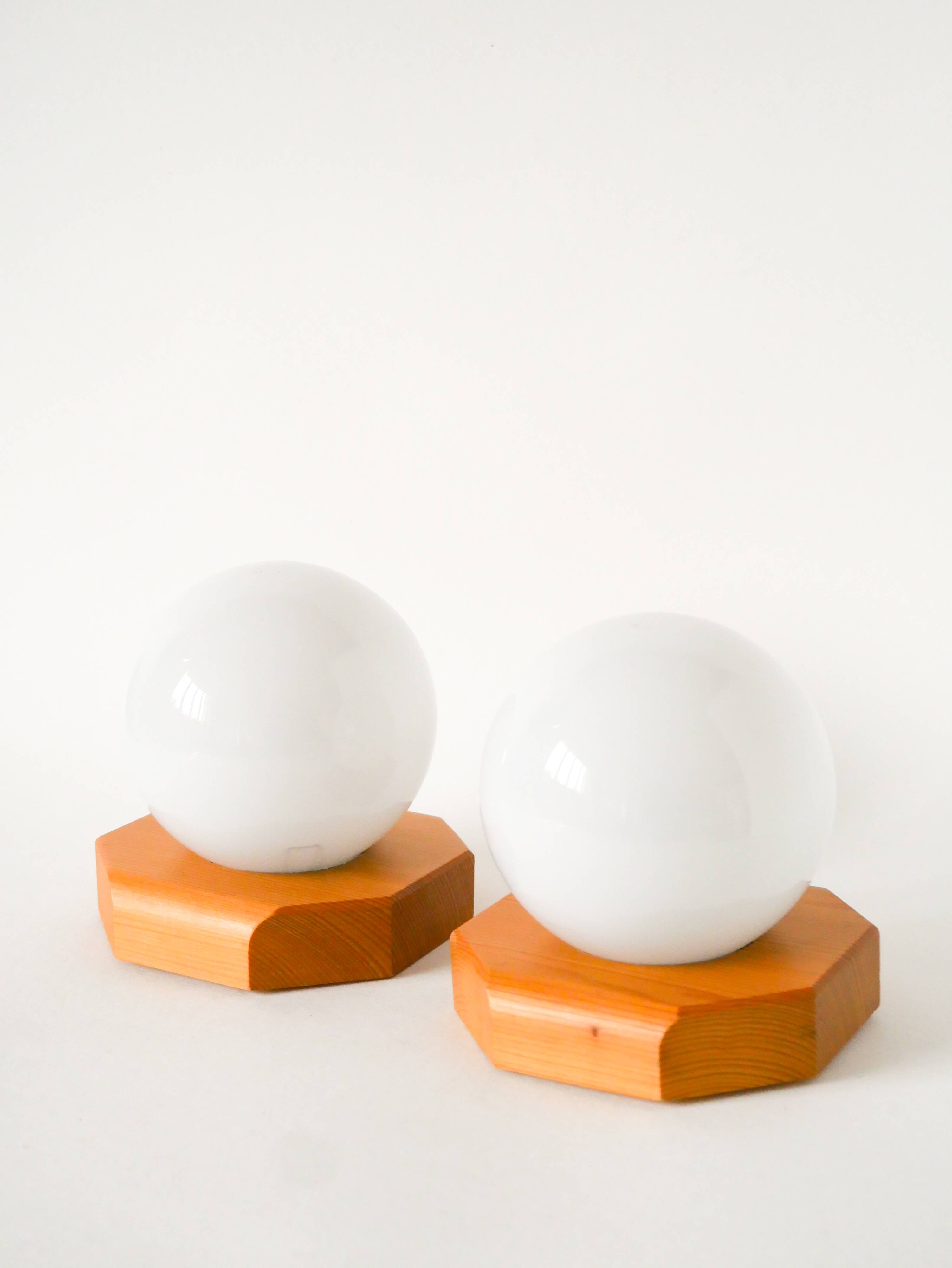 Pair of globe wall lights in opaline with a pine base, 1980.