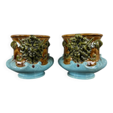 Pair of earthenware cachepots with a mask decoration, 19th century.