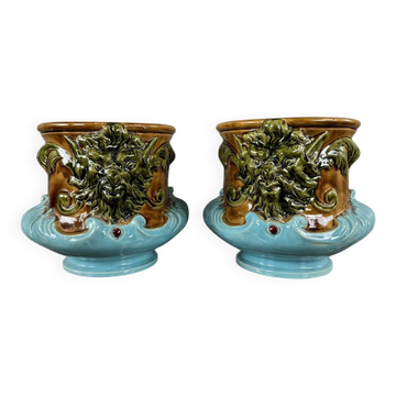 Pair of earthenware cachepots with a mask decoration, 19th century.