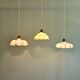 Trio of Art Deco pendant lights in scalloped opaline, 1920-30