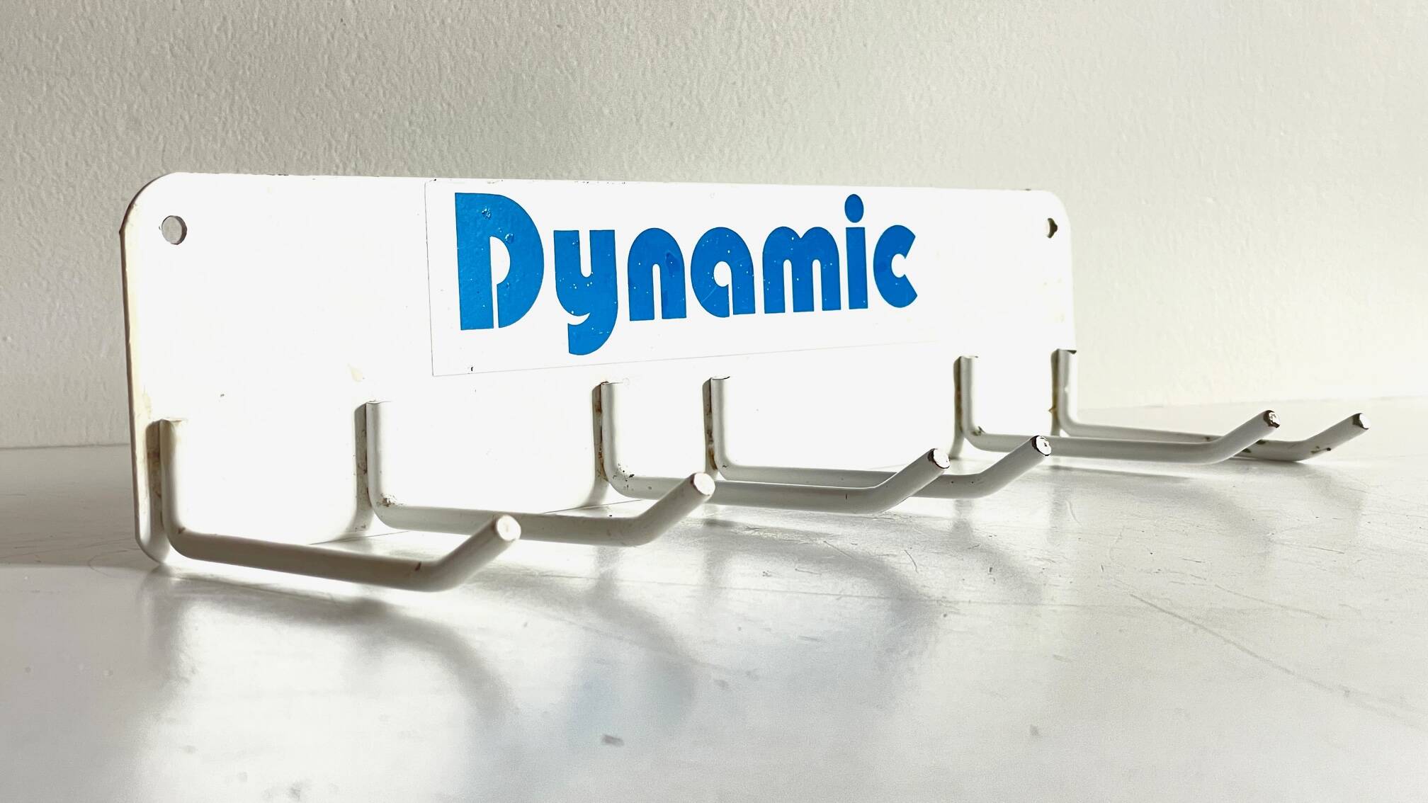 Vintage white metal wall trade coat rack