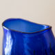 Blue blown glass vase and orange inclusion