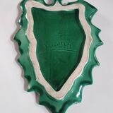 empty green ceramic pocket cup, small chips on the edges, signed