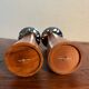 Pair of Guy Degrenne wooden and stainless steel candlesticks