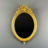 Miroir ovale doré style Louis XVI, XIXe siècle