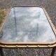 Table with an old ship porthole in brass and a metal base / 110 x 70 x 76 cm