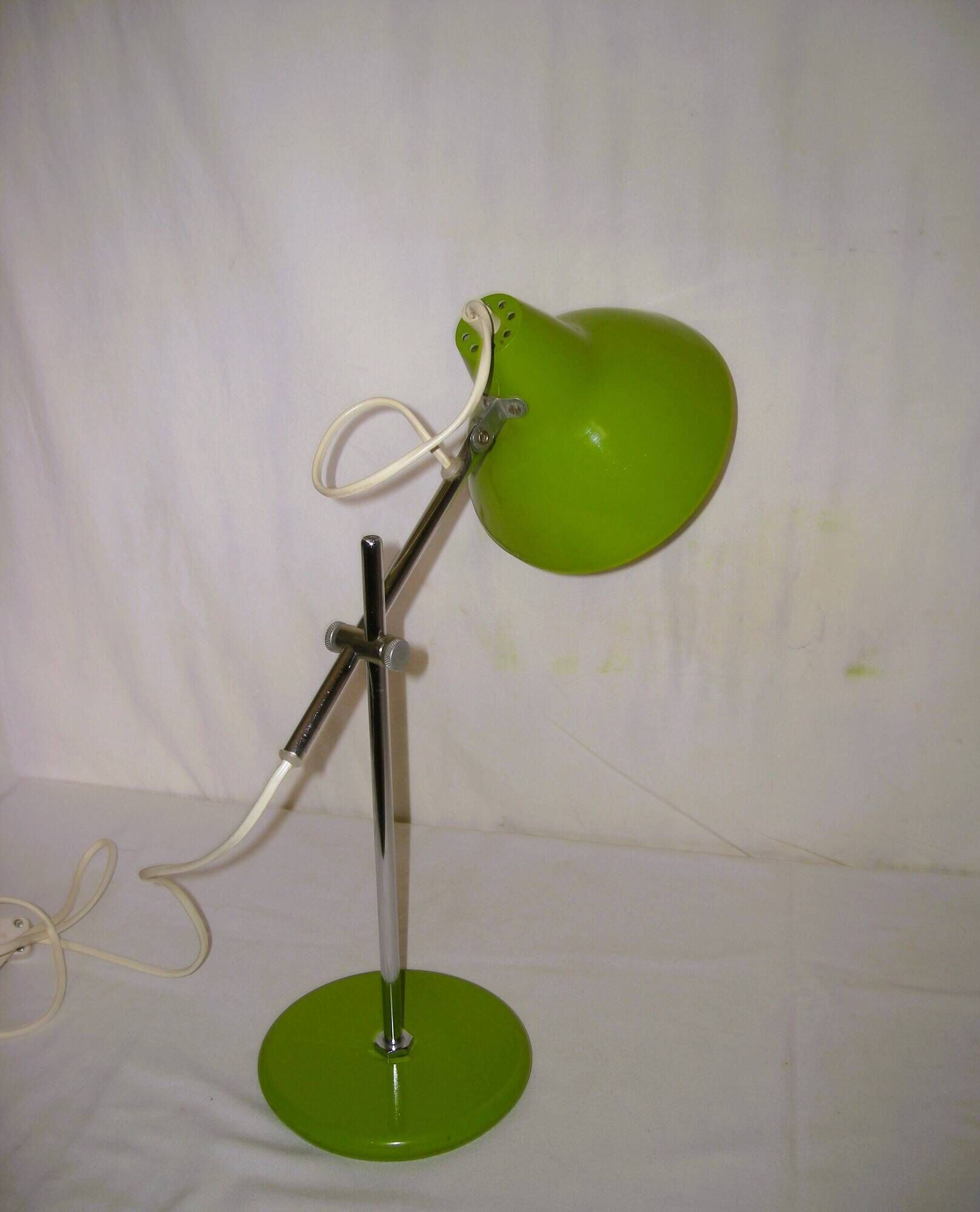 Green desk lamp with an arm from the 1970s.