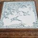 Antique musical trivet made of carved wood and Belle Époque earthenware.