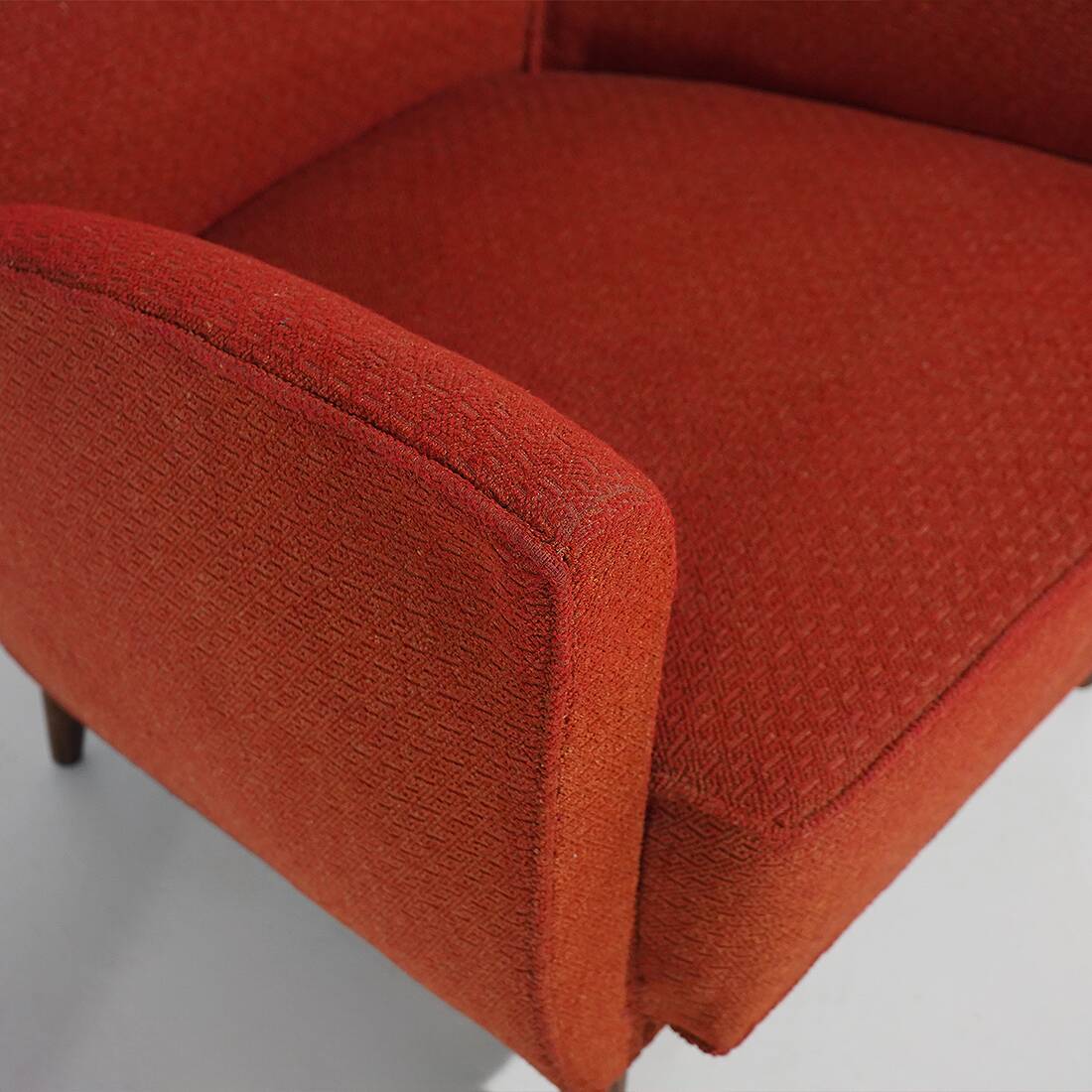 Pair of red armchairs with cone-shaped feet, 1950s