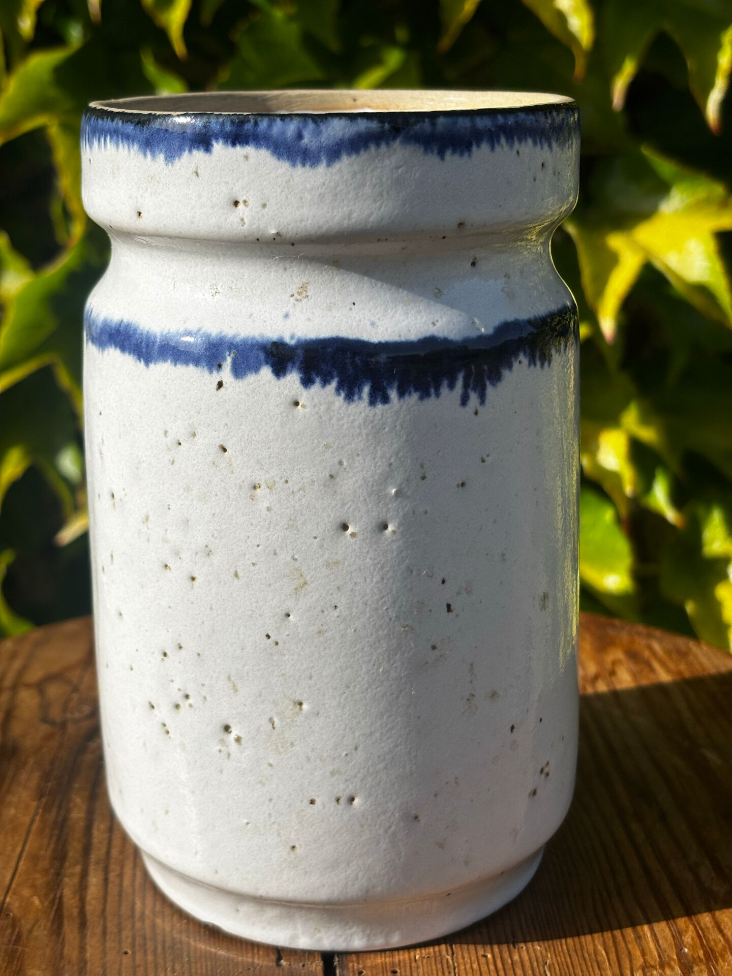Pretty pot or vase in glazed stoneware with blue drip effect.