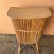 Vintage rattan bar from the 60s with rounded shapes and a shelf for glasses