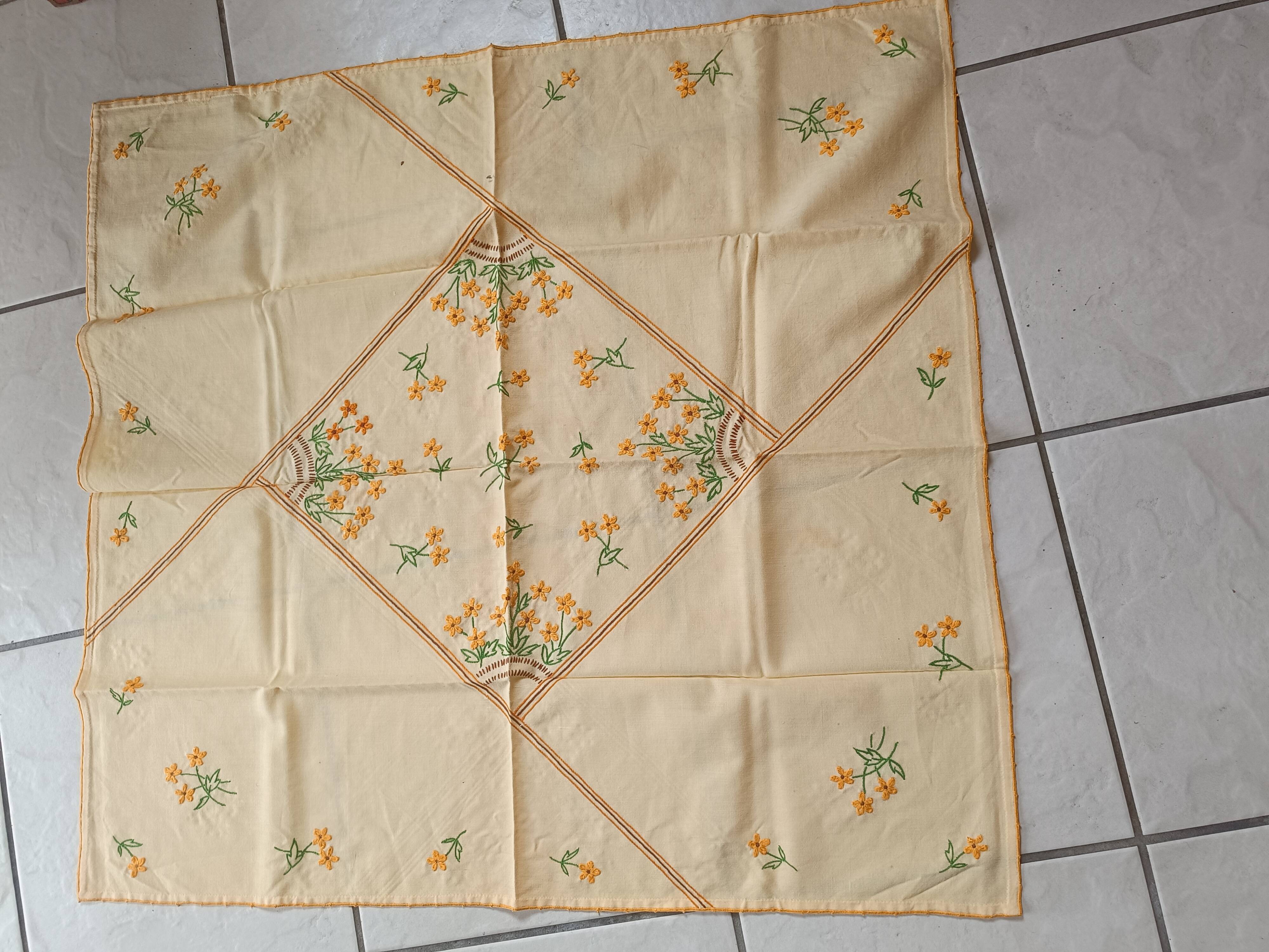 Hand-embroidered yellow square tablecloth.