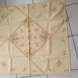 Hand-embroidered yellow square tablecloth.