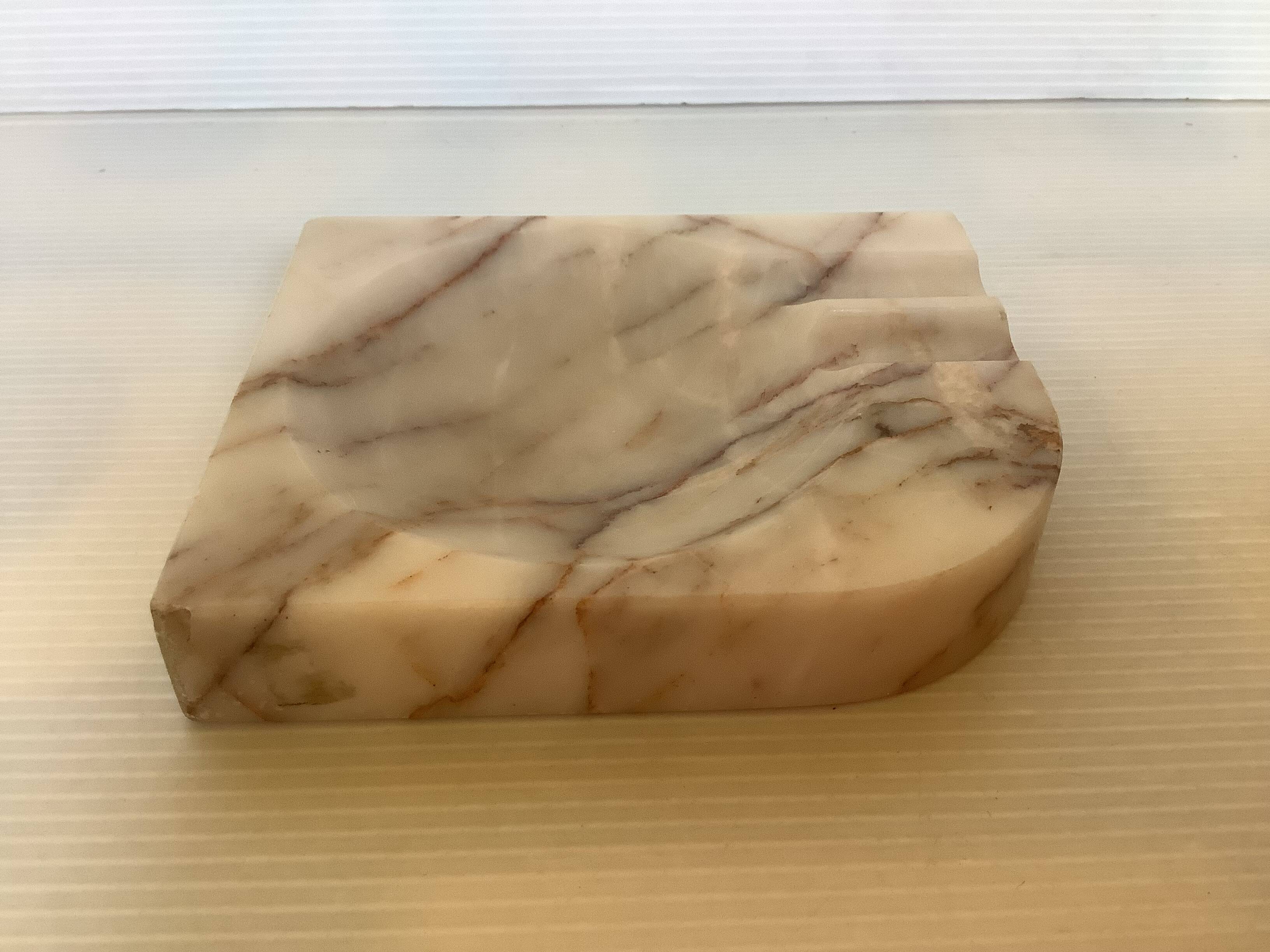 Asymmetrical marble ashtray emptier