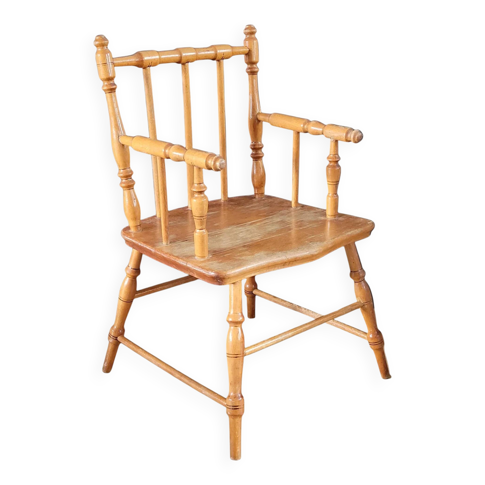 Antique wooden child's armchair from the early 20th century.