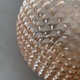 Spherical glass globe with pins. Salmon pink color