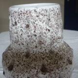 Spotted white ceramic vase with hollow form of tears