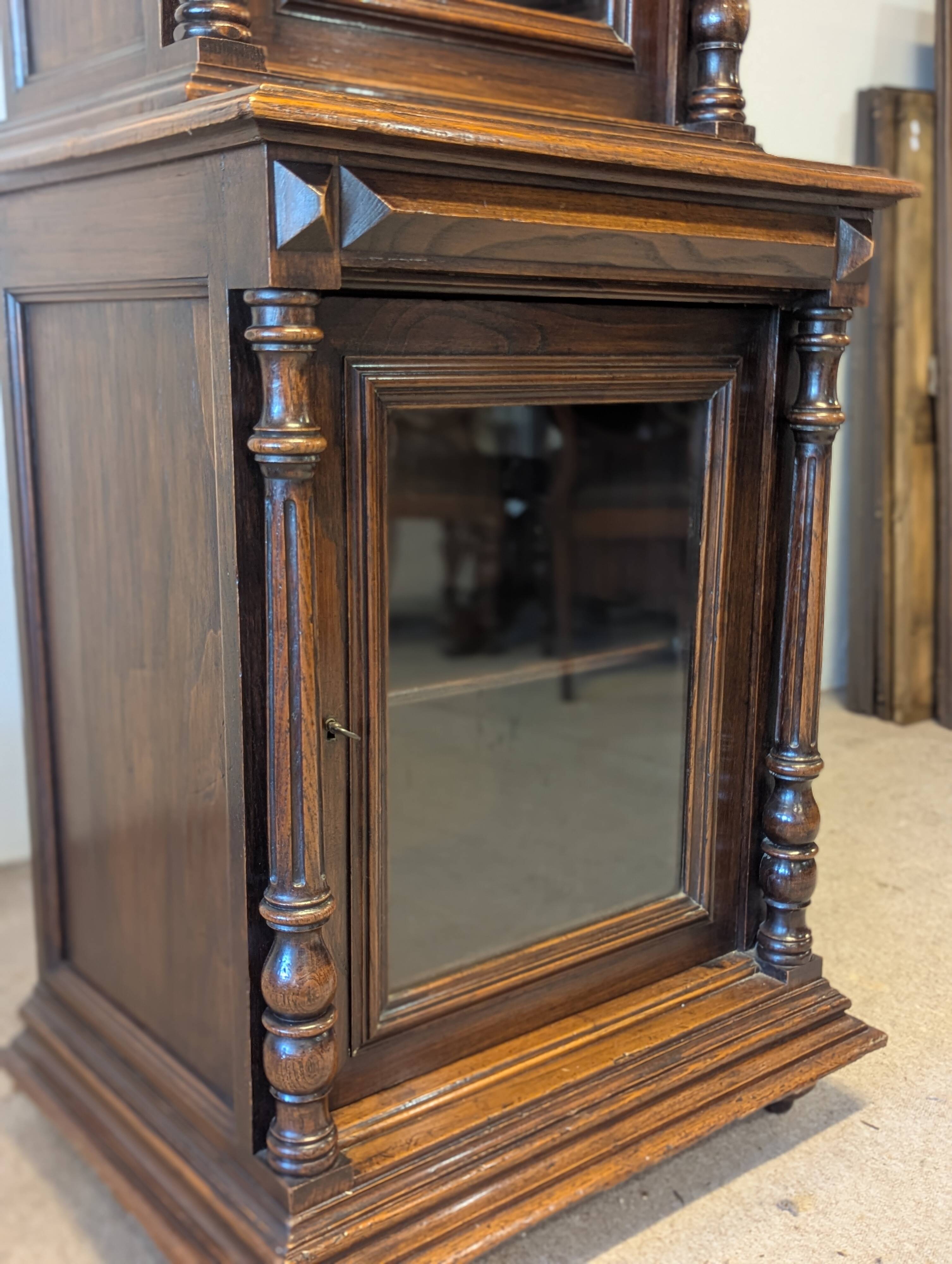 Two-body display cabinet in oak, Henri II style.