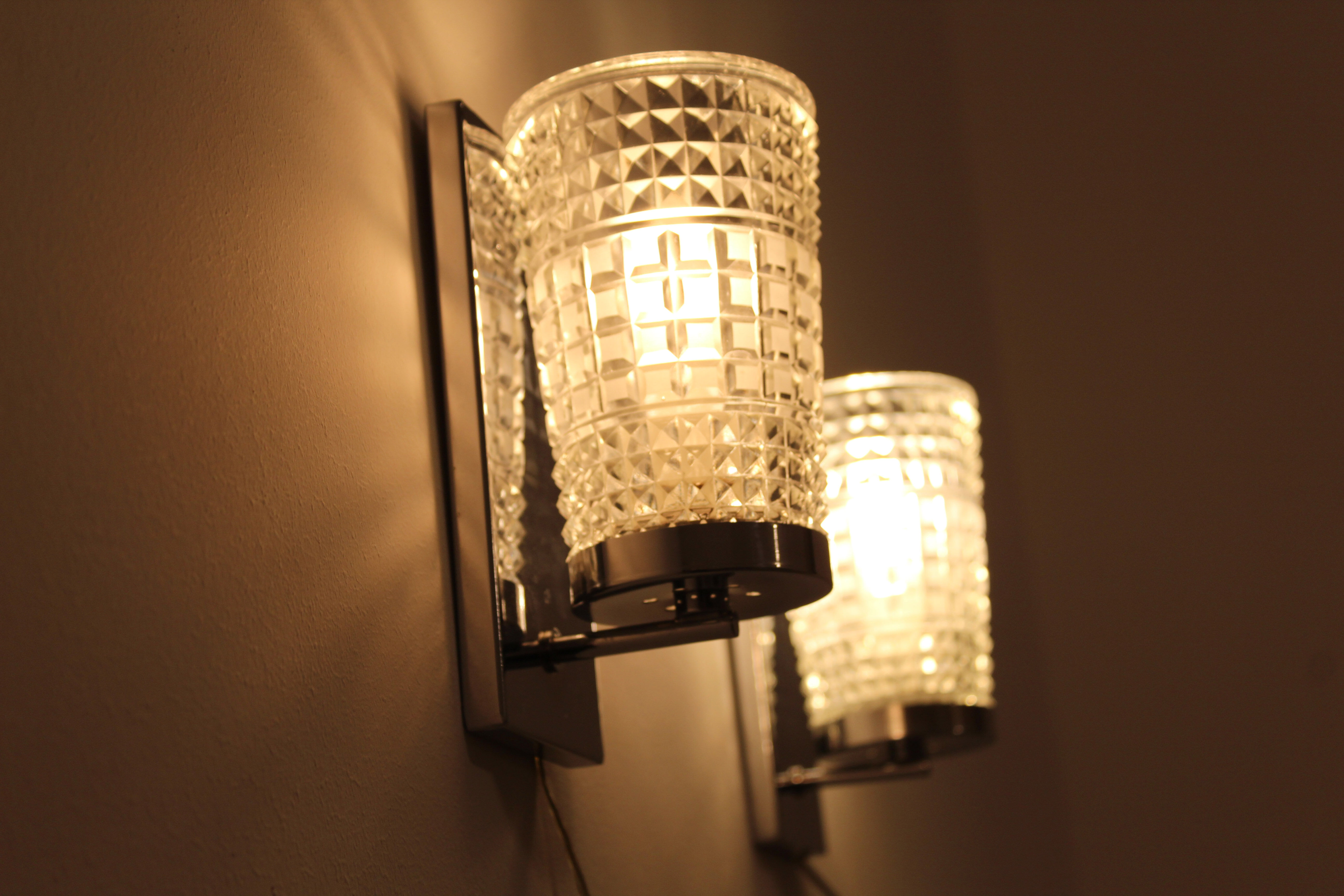 Wall lamps in worked glass and chromed metal, Italy 70's