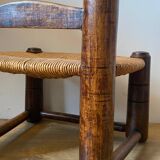 Low brutalist straw chair called fireplace chair