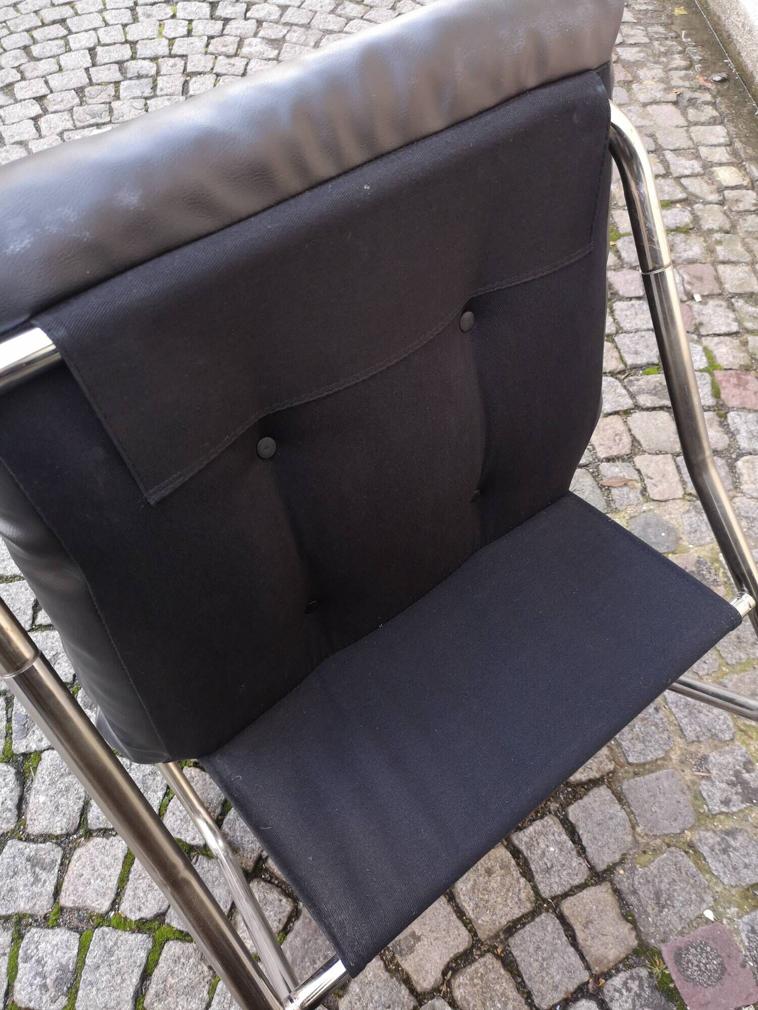 Tubular fireside chair in black skai and metal, design 1970