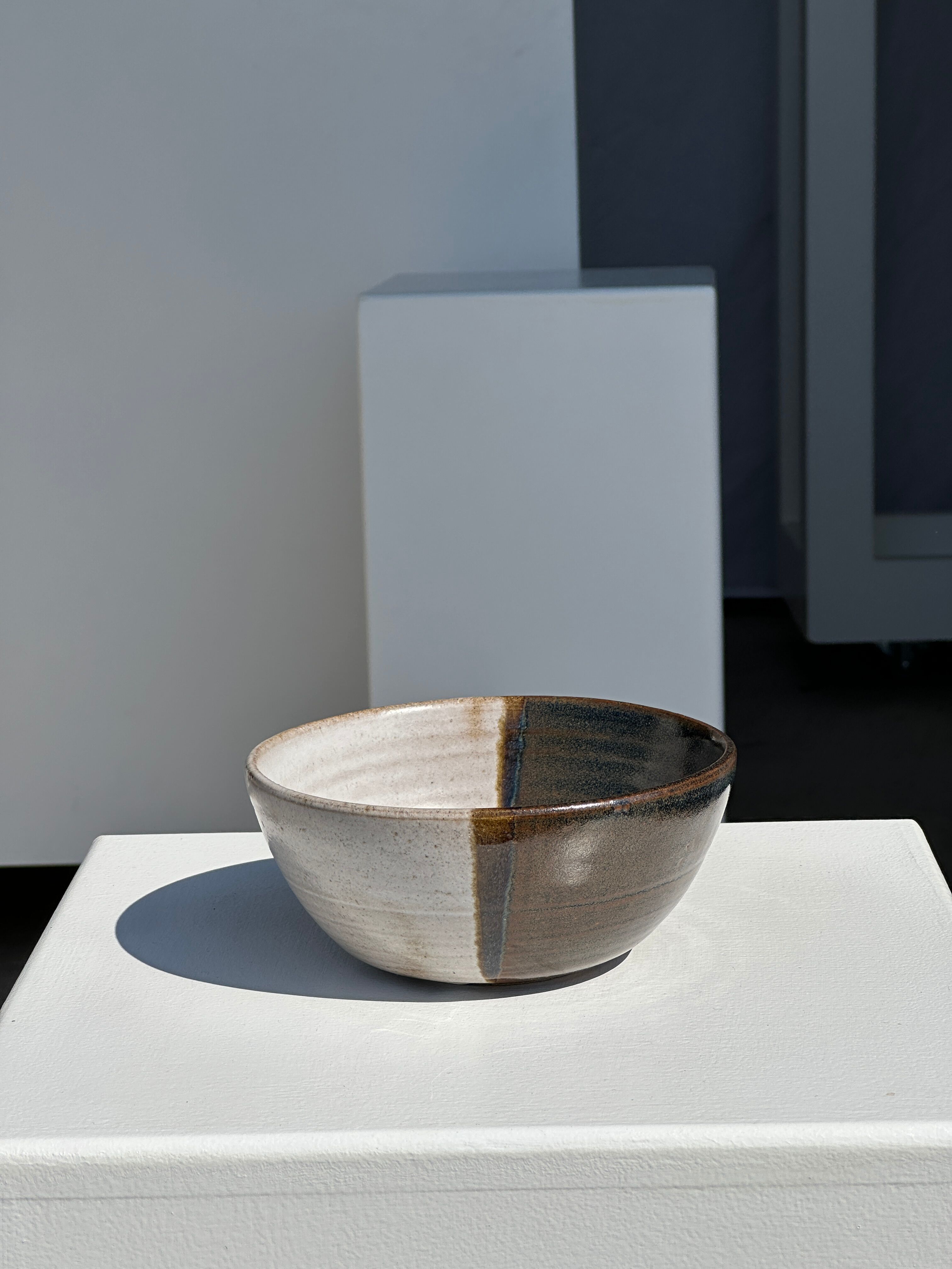 White and glossy brown two-tone ceramic bowl, matt earth