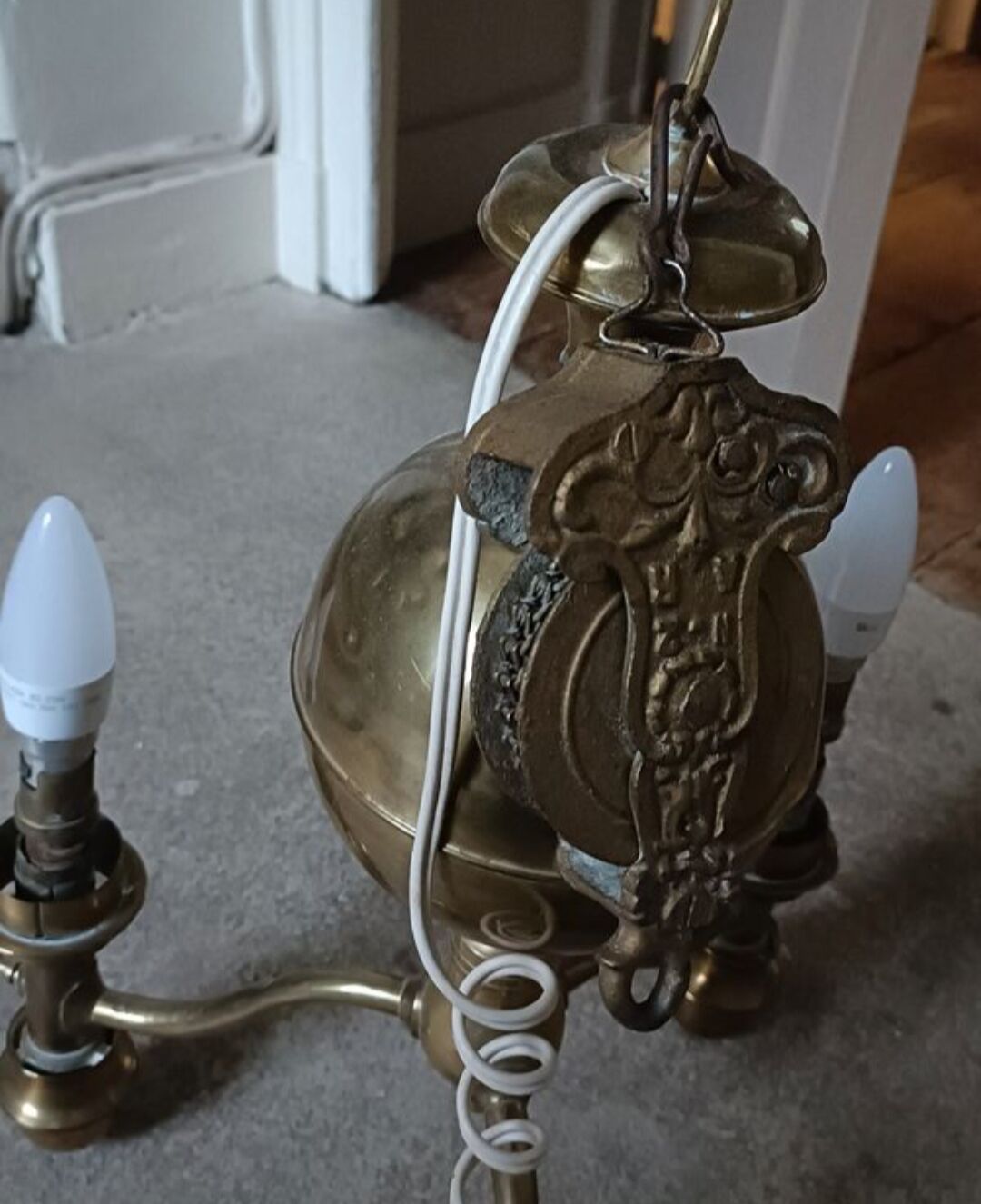 Brass chandelier with three flames.