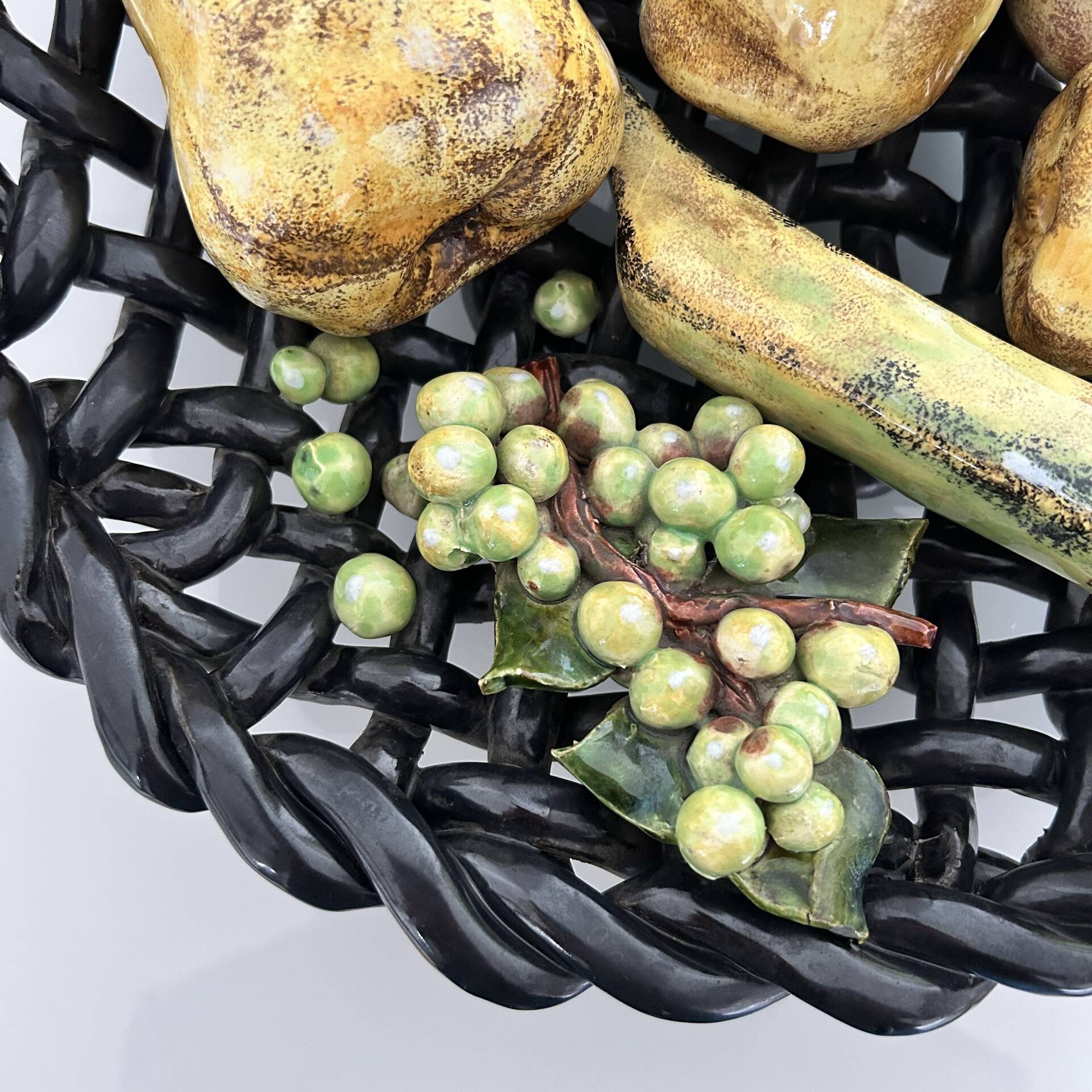 Large woven bowl and trompe l'œil fruits