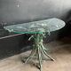Vintage console in patinated metal with reed leaves.