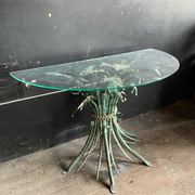 Vintage console in patinated metal with reed leaves.