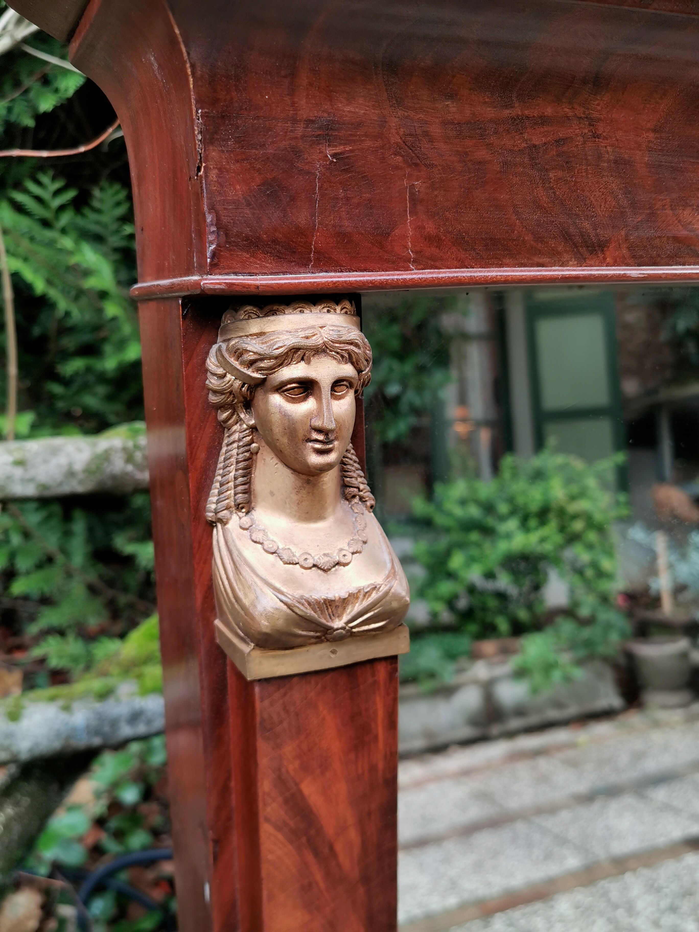 Mahogany pediment mirror with Empire-style cariatids. Return from Egypt