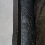 Black Art Deco design cow leather and wooden armchair with loose cushion