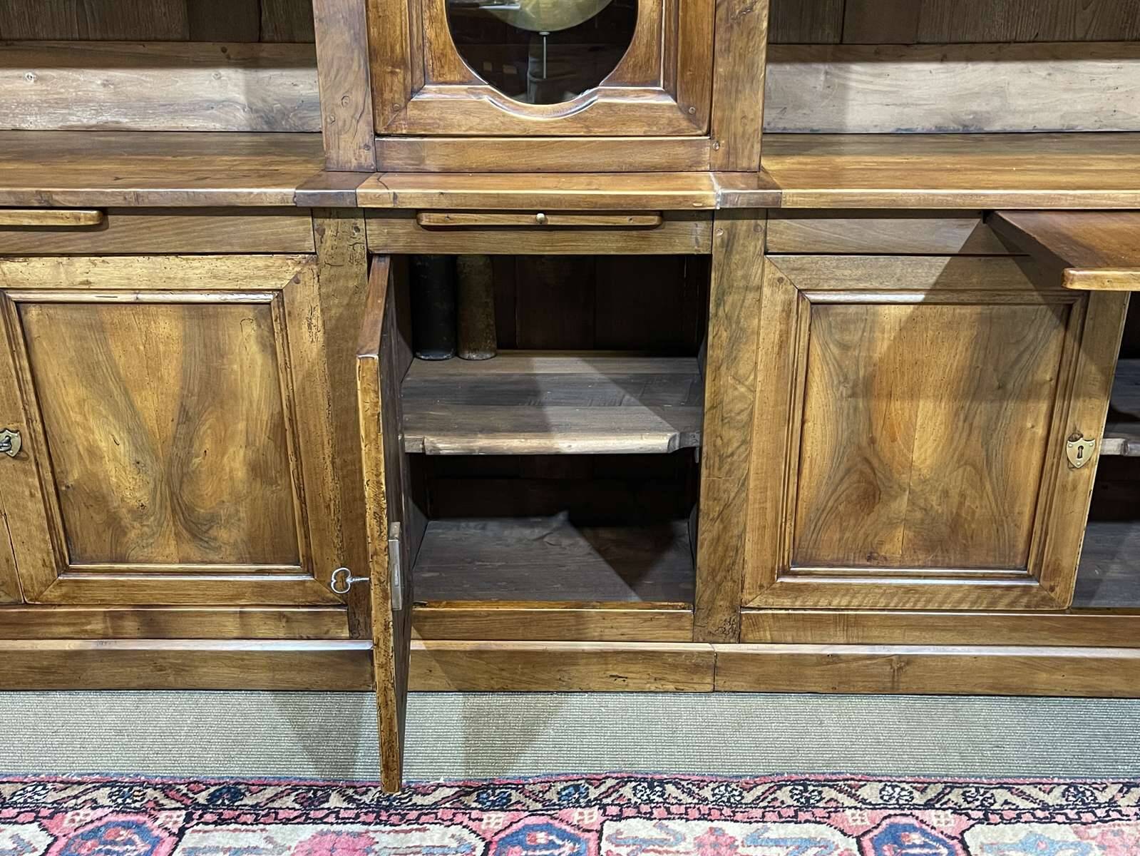 Library in walnut and oak from the early 20th century with its central clock.