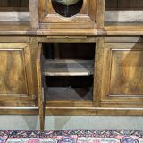 Library in walnut and oak from the early 20th century with its central clock.