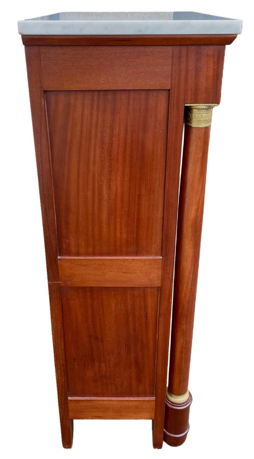 Empire secretary with white marble top in mahogany and brass, 6 drawers.