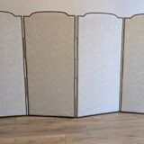 Vintage white faux leather screen with four studded panels, elegant decor.