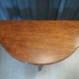 Half-moon mahogany game table on casters