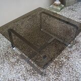 Table basse Roche Bobois 1970 verre fumé piètement en métal chromé.