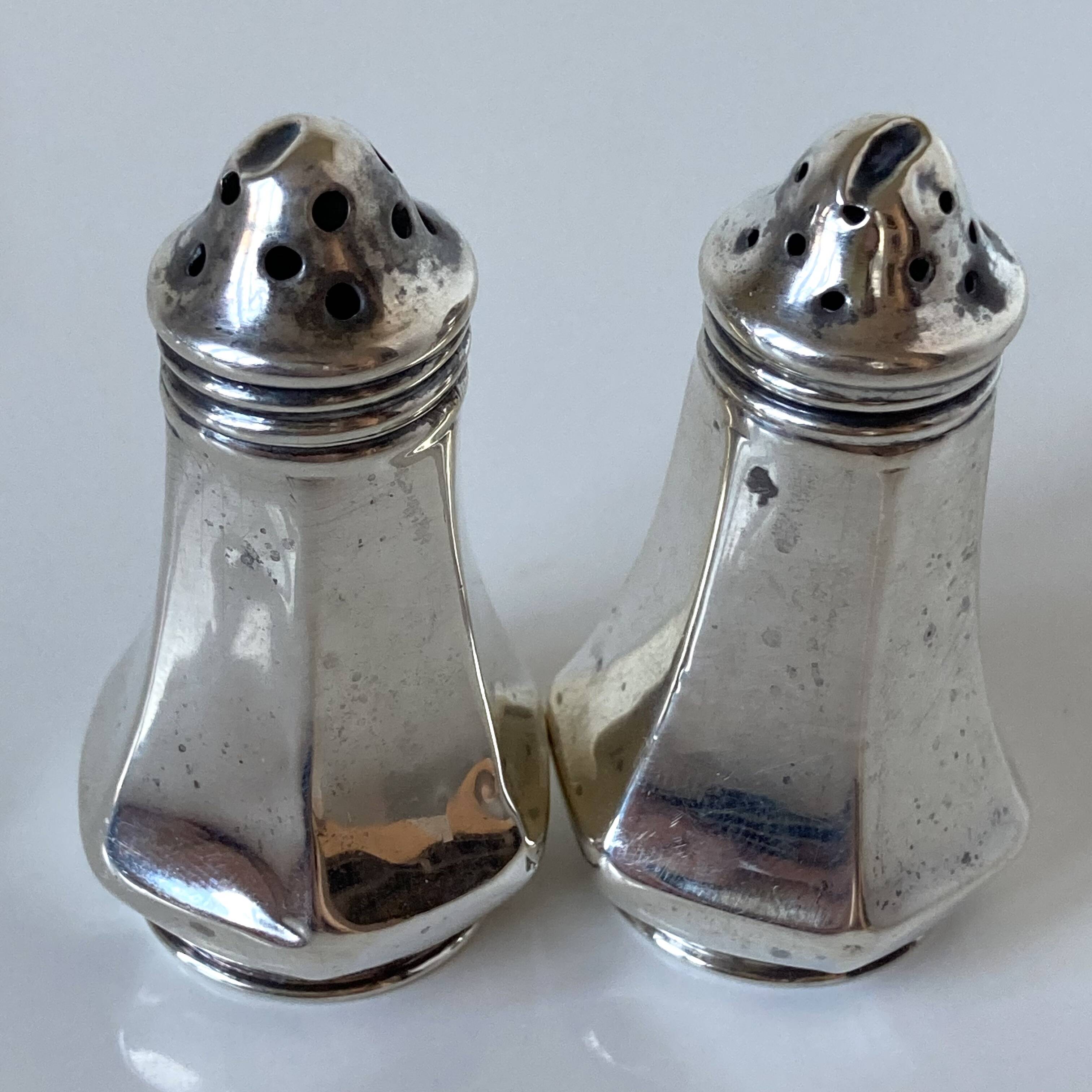Antique salt and pepper shakers in solid English silver