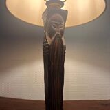 Old lamp with carved wooden base representing a wise man