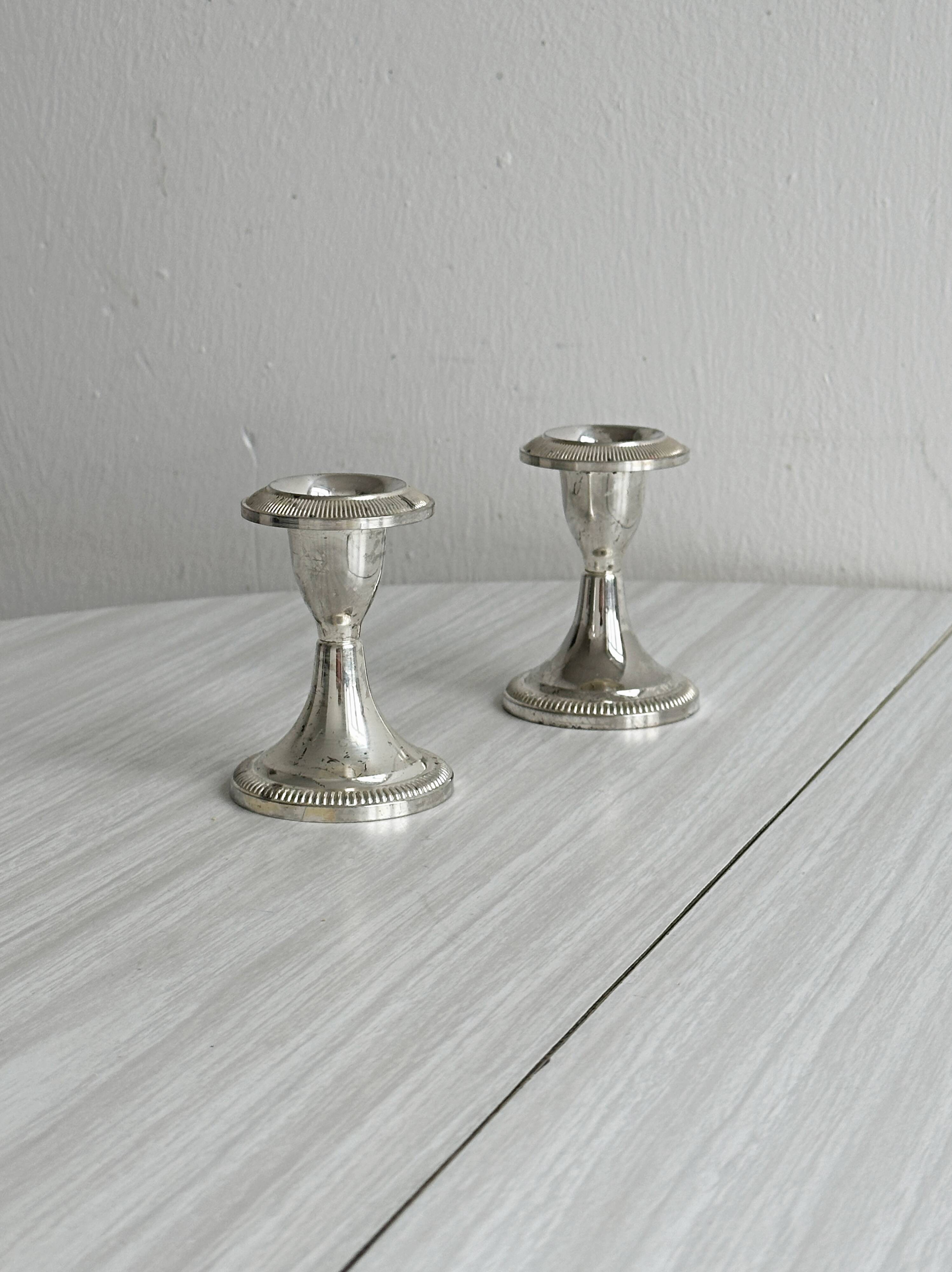 Set of 2 vintage silver-plated metal candle holders.