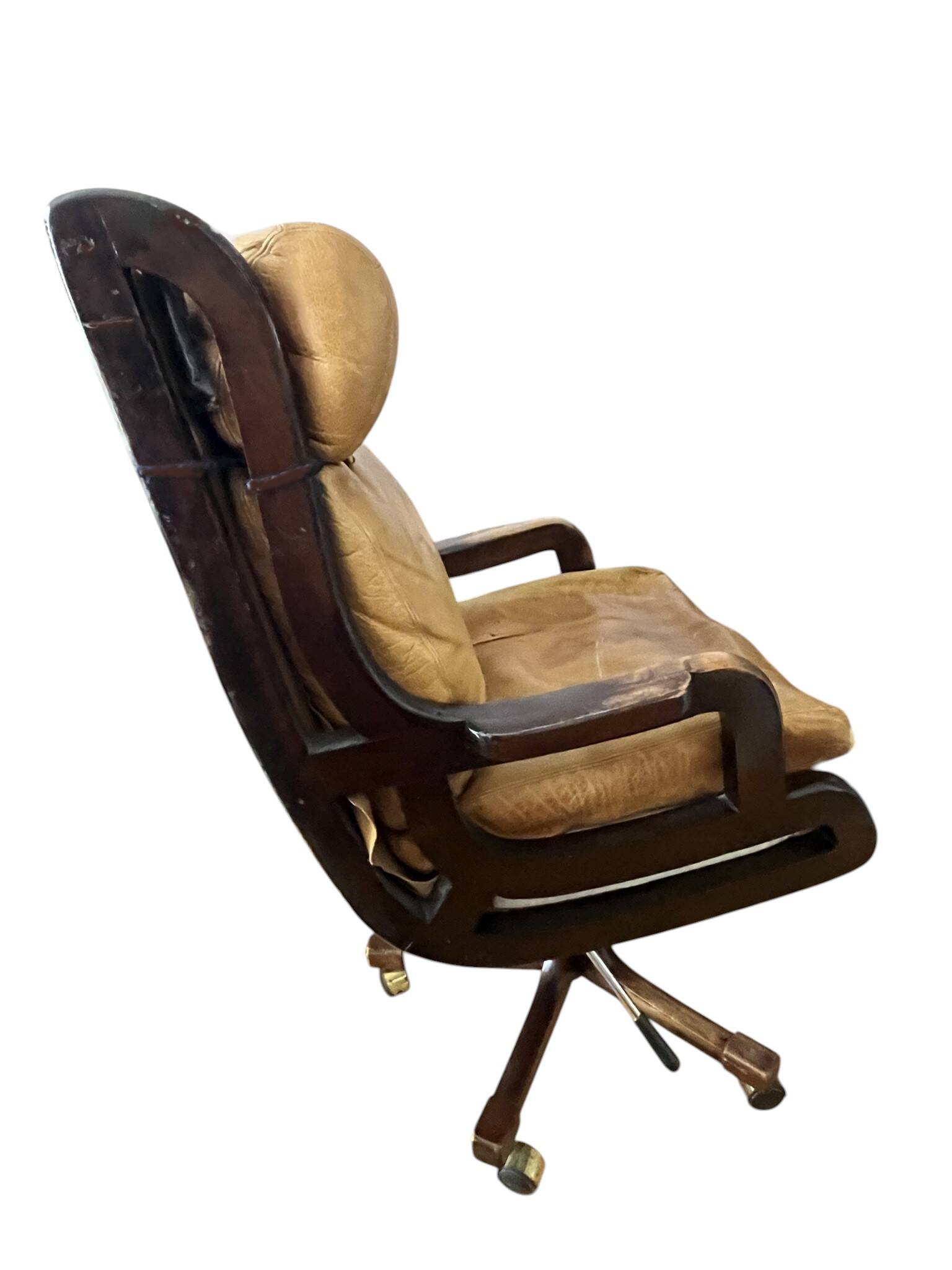 Vintage mahogany and havana leather office chair with wheels from around 1970.