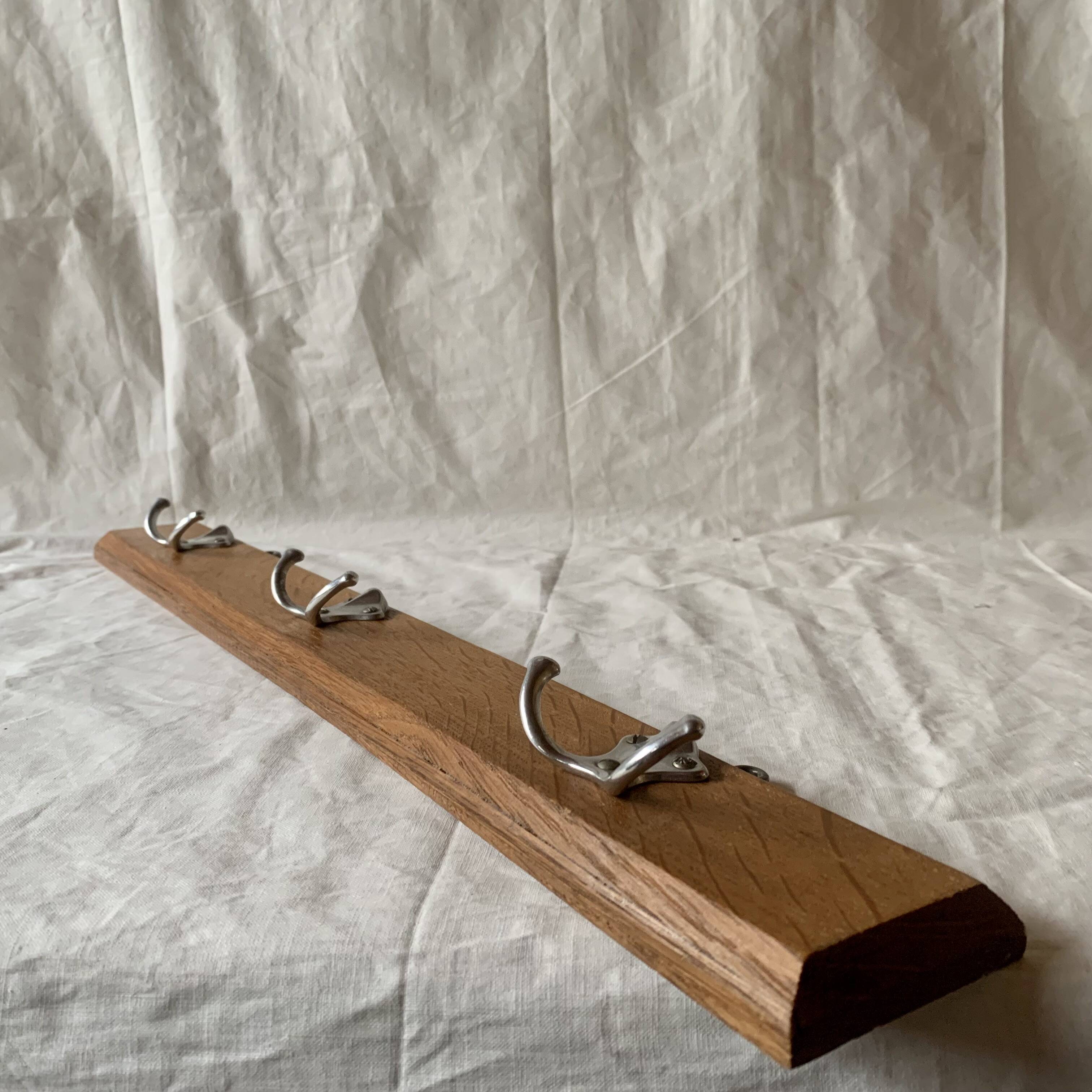Vintage wooden wall-mounted coat rack with three double hooks
